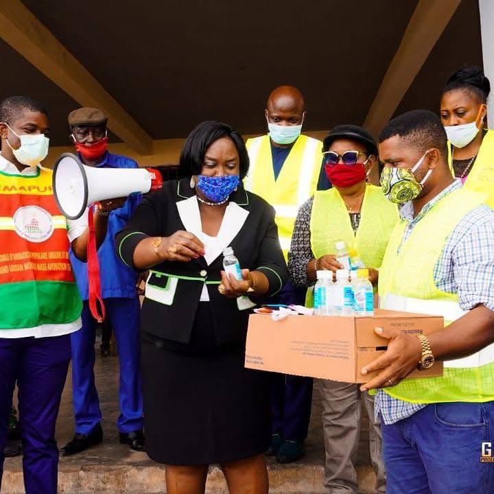 COVID 19 handing over a carton of face mask