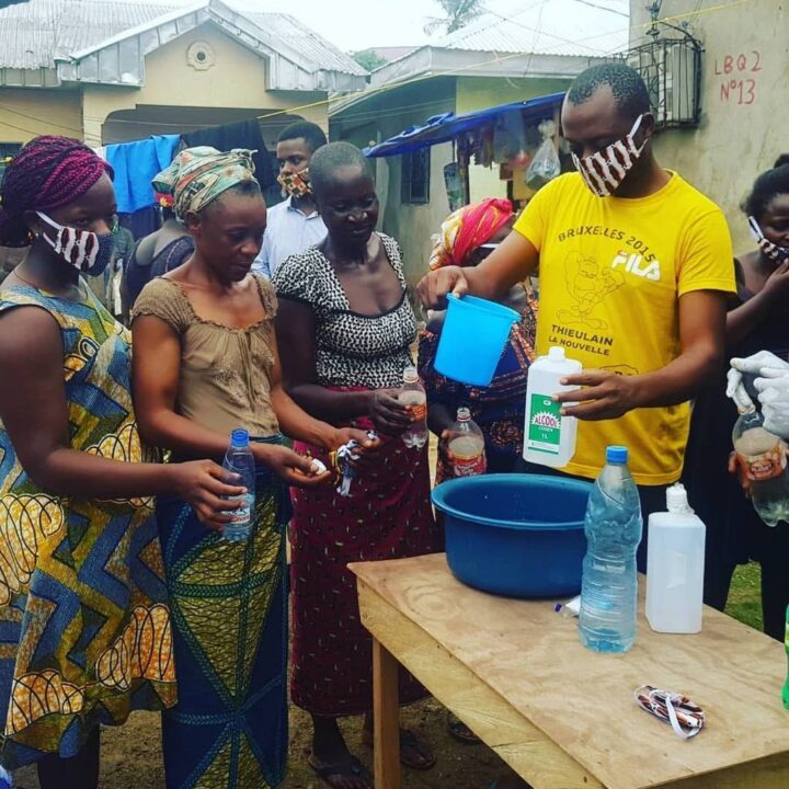Lady handing over hand sanitizer